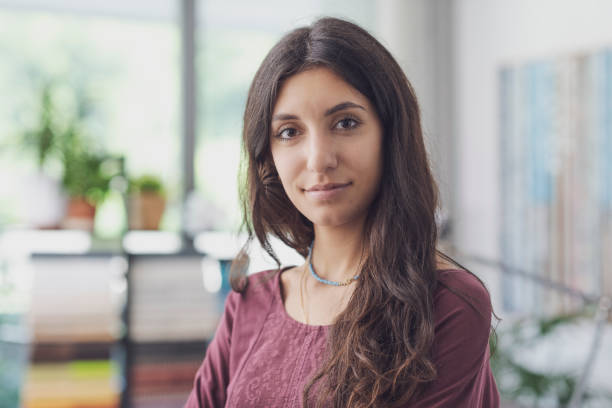 istock Happy young woman posing indoors 1441370833