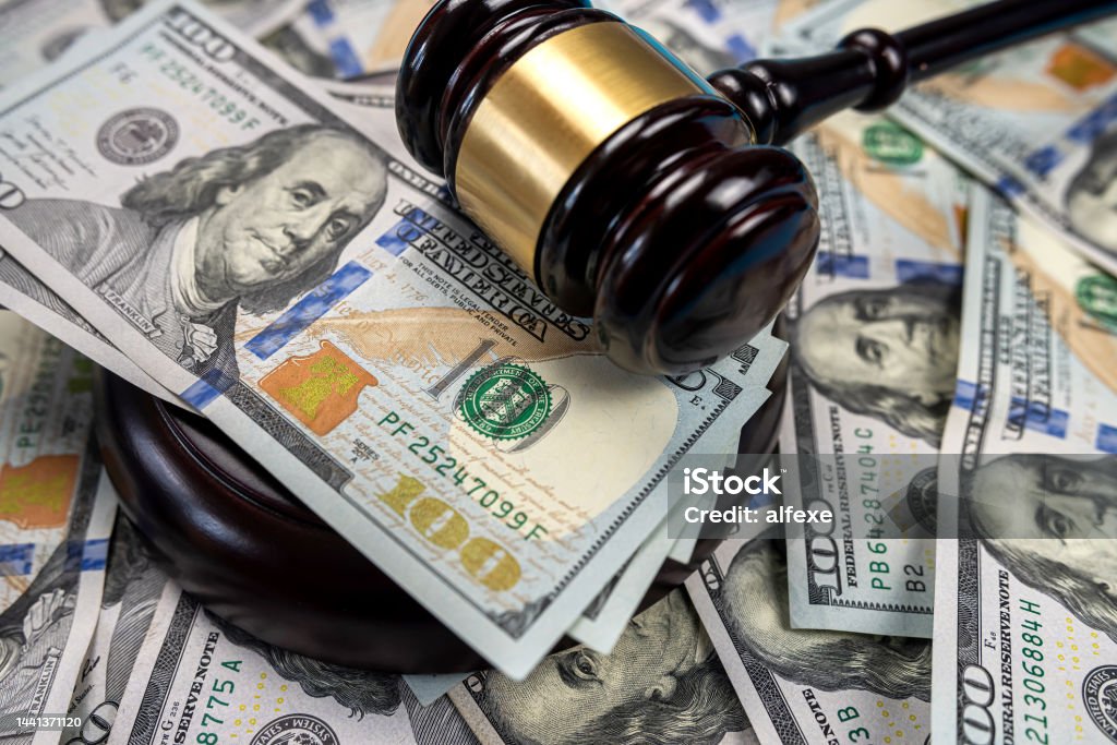 Gavel cash dollar bills and financial crimes. Gavel cash dollar bills and financial crimes. Justice on dollar bills and legal concept Lawsuit Stock Photo