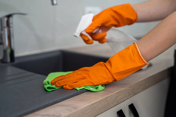 istock closeup view, female hand wearing rubber protective gloves and clean kitchen 1441371766