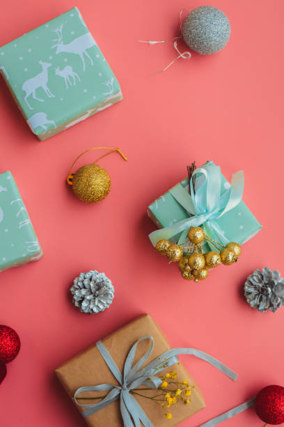 istock Small Christmas gifts on pink background 1441371993