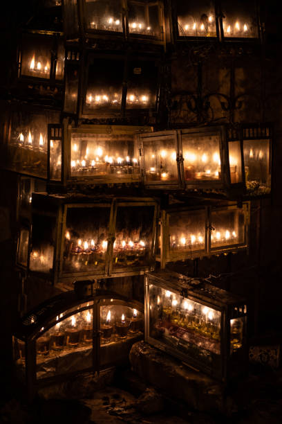 Glowing Hanukkah menorahs lit with small vials of oil burn in protective glass housing outside an apartment building in Jerusalem during the celebration of the Festival of Lights in Israel