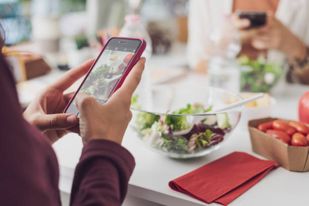 istock People having lunch break and using their smartphones 1441373006