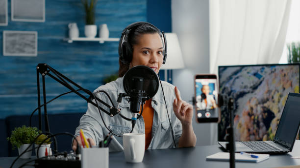istock Excited famous vlogger recording video with smartphone while talking to public 1441373671