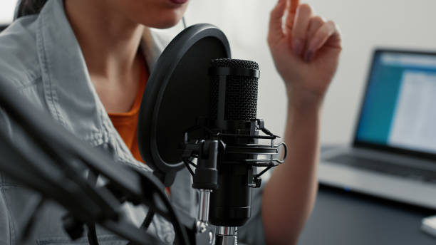 istock Internet live radio talk show host recording remote podcast while talking to audience 1441373688