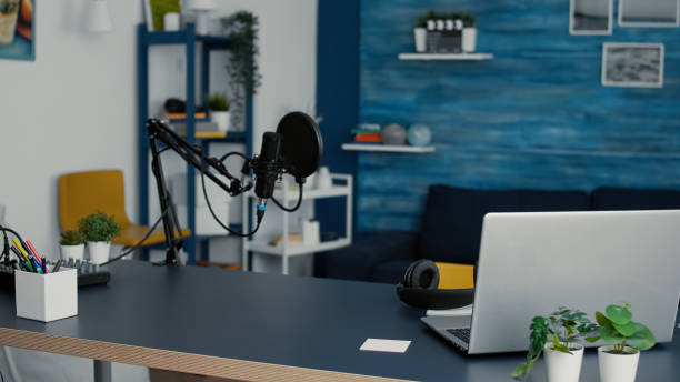 istock Empty living room studio desk with modern laptop and professional podcast microphone 1441373730