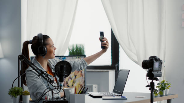istock Famous internet influencer taking selfie photo with smartphone while streaming 1441374483