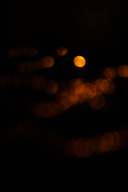 istock Abstract orange and gold dark background with glowing turquoise particles. 1441374860