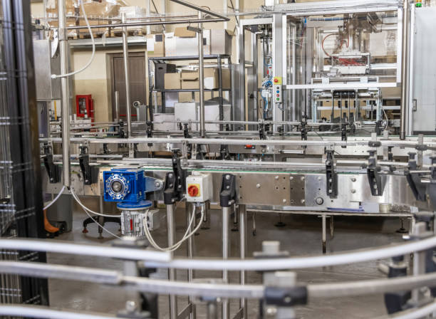 istock Industrial bottling machine at modern wine factory. Automatic conveyor line for wine-producing 1441375479