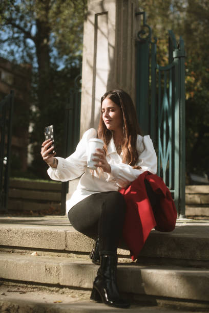 istock Young woman taking a selfie picture with a coffee cup 1441376378