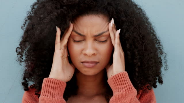 Burnout, headache and anxiety black woman or young student on blue wall for mental health problem, risk and mistake. Fatigue, brain fog and sad girl for stress, angry and frustrated with pain