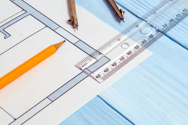 istock House diagrams and accessories for drawing lying on construction drawing and a blue workshop table for projects engineer jobs 1441376562
