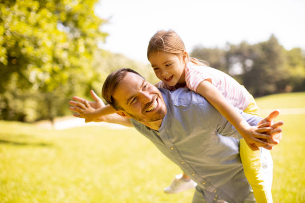 istock Father with daughter having fun at the park 1441376966