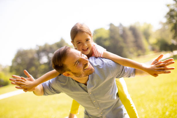 istock Father with daughter having fun at the park 1441376970