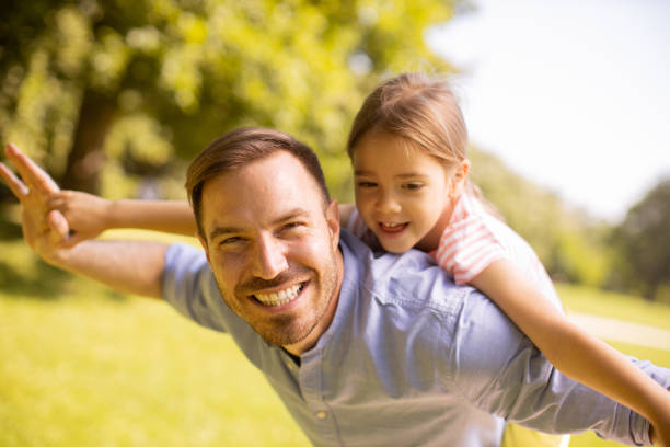 istock Father with daughter having fun at the park 1441376977