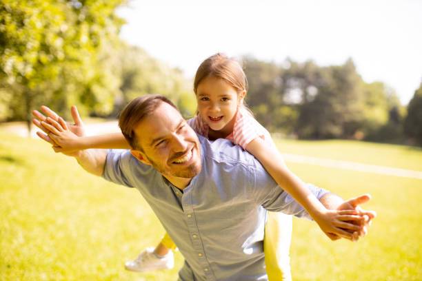 istock Father with daughter having fun at the park 1441376980