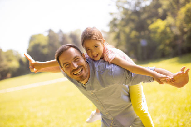 istock Father with daughter having fun at the park 1441376982