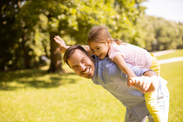 istock Father with daughter having fun at the park 1441376986