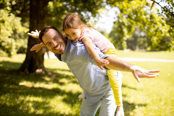 istock Father with daughter having fun at the park 1441377004