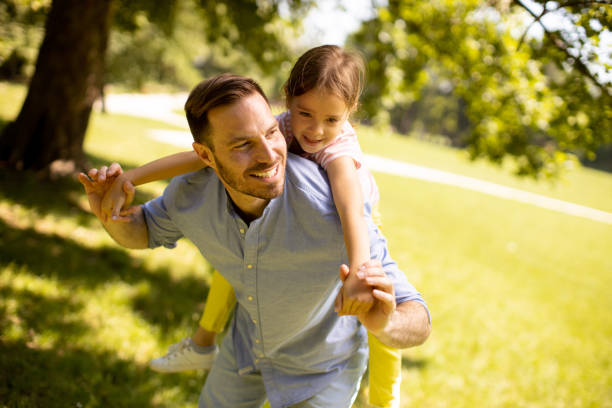 istock Father with daughter having fun at the park 1441377006