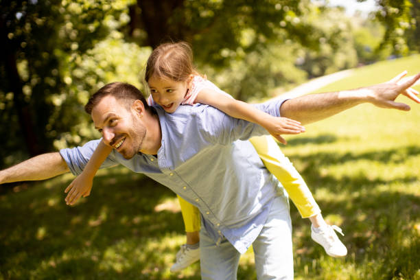 istock Father with daughter having fun at the park 1441377024