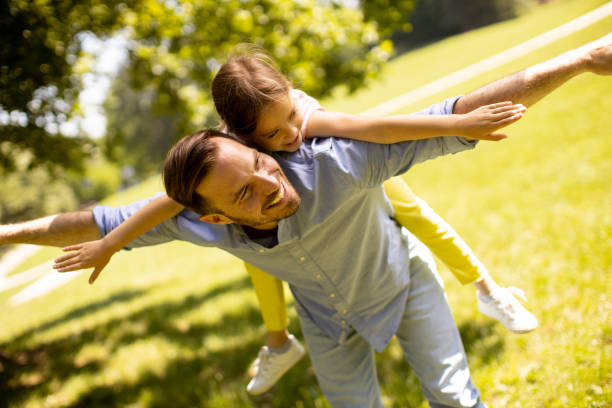 istock Father with daughter having fun at the park 1441377037