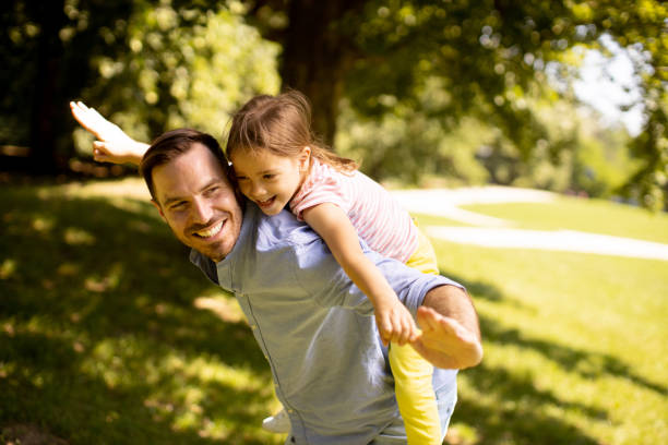 istock Father with daughter having fun at the park 1441377048