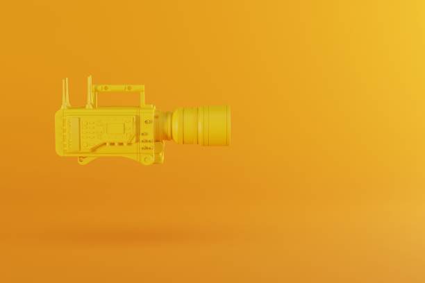 istock A yellow film camera on a pastel yellow background. 1441378859