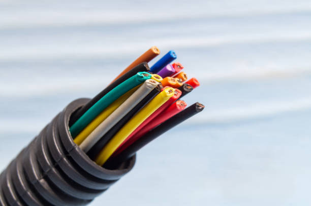 istock Many multicolored wires in protective corrugation closeup on a blue background 1441380395