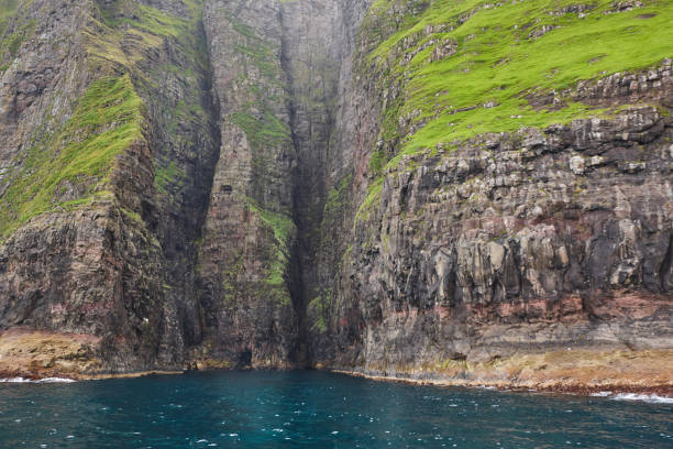 istock Stunning green cliffs and caves. Atlantic ocean, Faroe islands. 1441380532