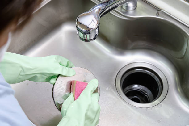 istock Women cleaning the kitchen sink with sponge 1441380702