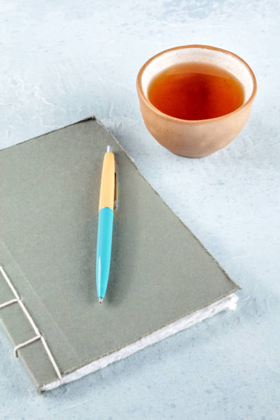 istock A diary. A paper journal with a pen and a cup of tea on a desk 1441380776