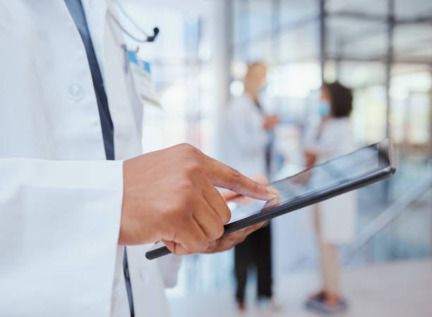 man hands of hospital doctor with tablet to search through digital medicine clinic medical records, files or documents. professional healthcare worker, employee or surgeon doing information research - reference file imagens e fotografias de stock