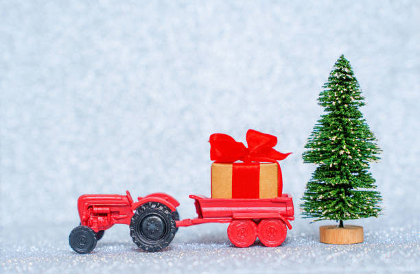 istock Giant Christmas gift box delivered by toy tractor 1441382162