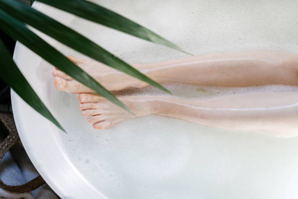 istock Female legs in bath with warm water and soap bubbles 1441382800