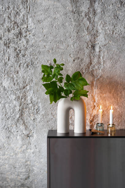 istock ceramic vase with leaf branch and candles on shelf indoors 1441382998