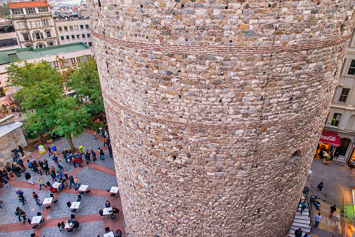Istanbul, Turkey - October 2014: Tourists and locals under Galata Tower restaurant, aerial view.