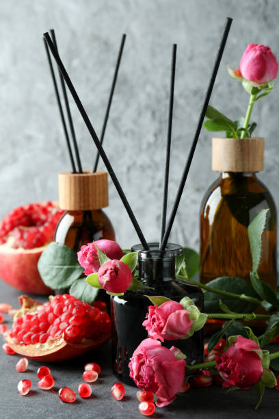 istock Diffusers, flowers and pomegranate on dark wooden table 1441384816