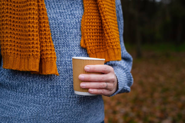 istock Cup coffee in hand in the woods 1441384951