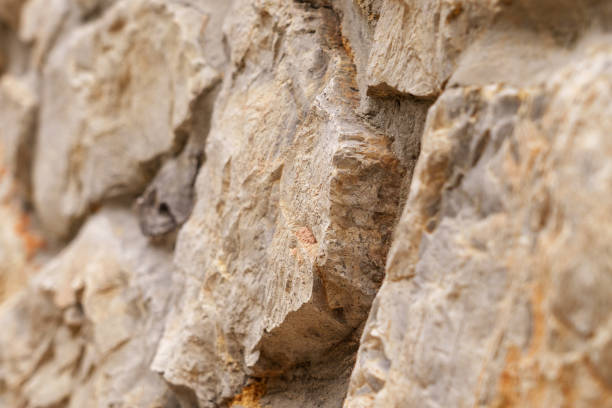 istock Old rough stone wall with weathered abstract cracked texture 1441386081