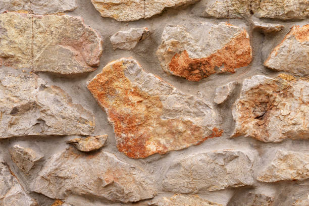 istock Old rough stone wall with weathered abstract cracked texture 1441386082