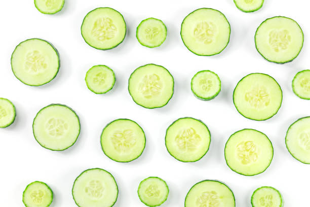 istock Fresh cucumber slices on a white background, overhead flat lay shot 1441386713