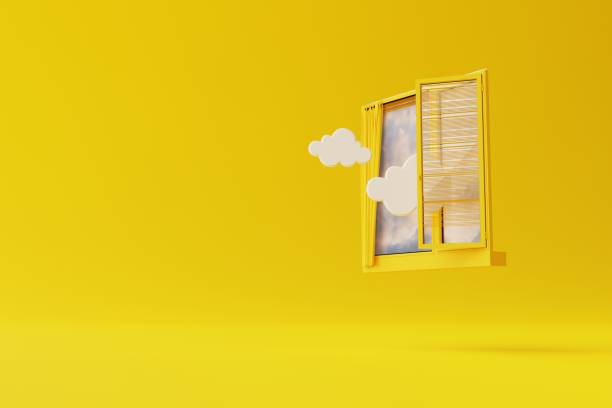 istock An isolated window on a yellow background with outgoing clouds and sky as a look. 1441388313