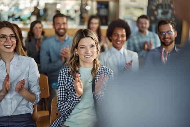 istock Happy entrepreneurs applauding on a seminar in board room. 1441388498