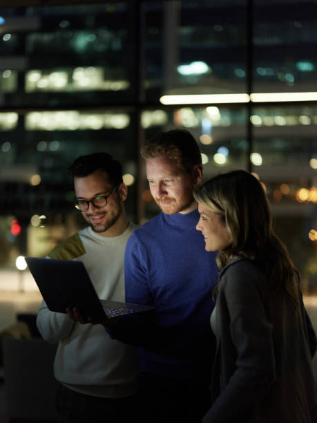 istock Young entrepreneurs reading an e-mail on laptop late in the office. 1441388679