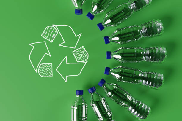 istock Plastic bottles with the recycling icon and painted recycling arrows. 1441389376