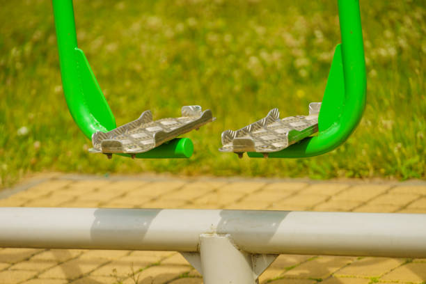 Outdoor gym in public park during summer spring sunny day with nobody. Sport machine equipment outside.