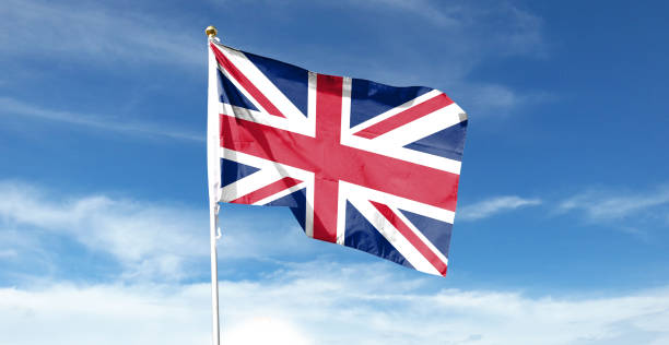 istock British flag on cloudy sky. waving in the sky 1441390486