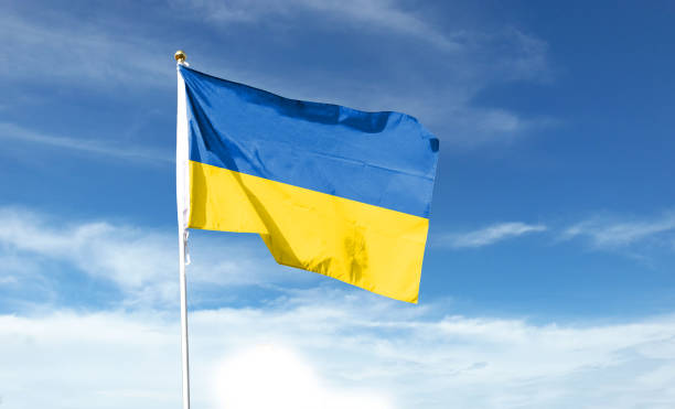 istock Ukrainian flag on cloudy sky. waving in the sky 1441392624