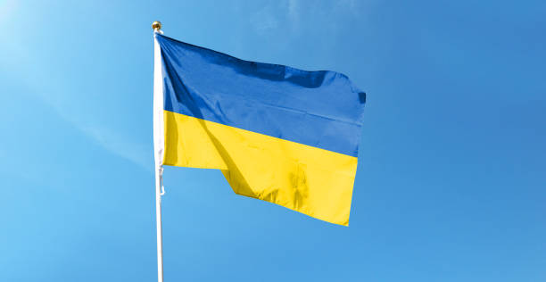 istock Ukrainian flag on cloudy sky. waving in the sky 1441392778