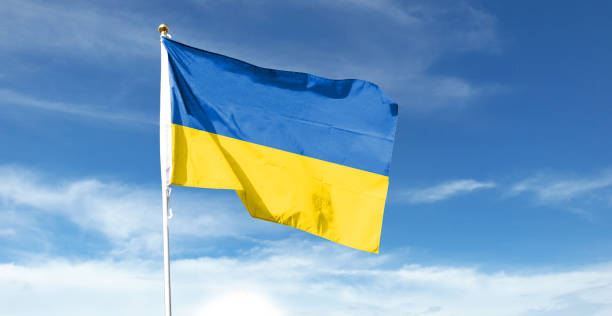 istock Ukrainian flag on cloudy sky. waving in the sky 1441393555